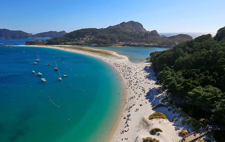 Aerial view of the white crescent of Praia de Rodas and its turquoise water on the Cíes Islands